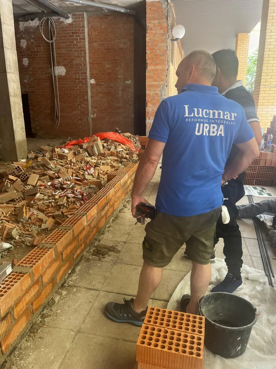 Equipo de LUCMAR URBA levantando tabiquería de ladrillo en la reforma de un local – LUCMAR